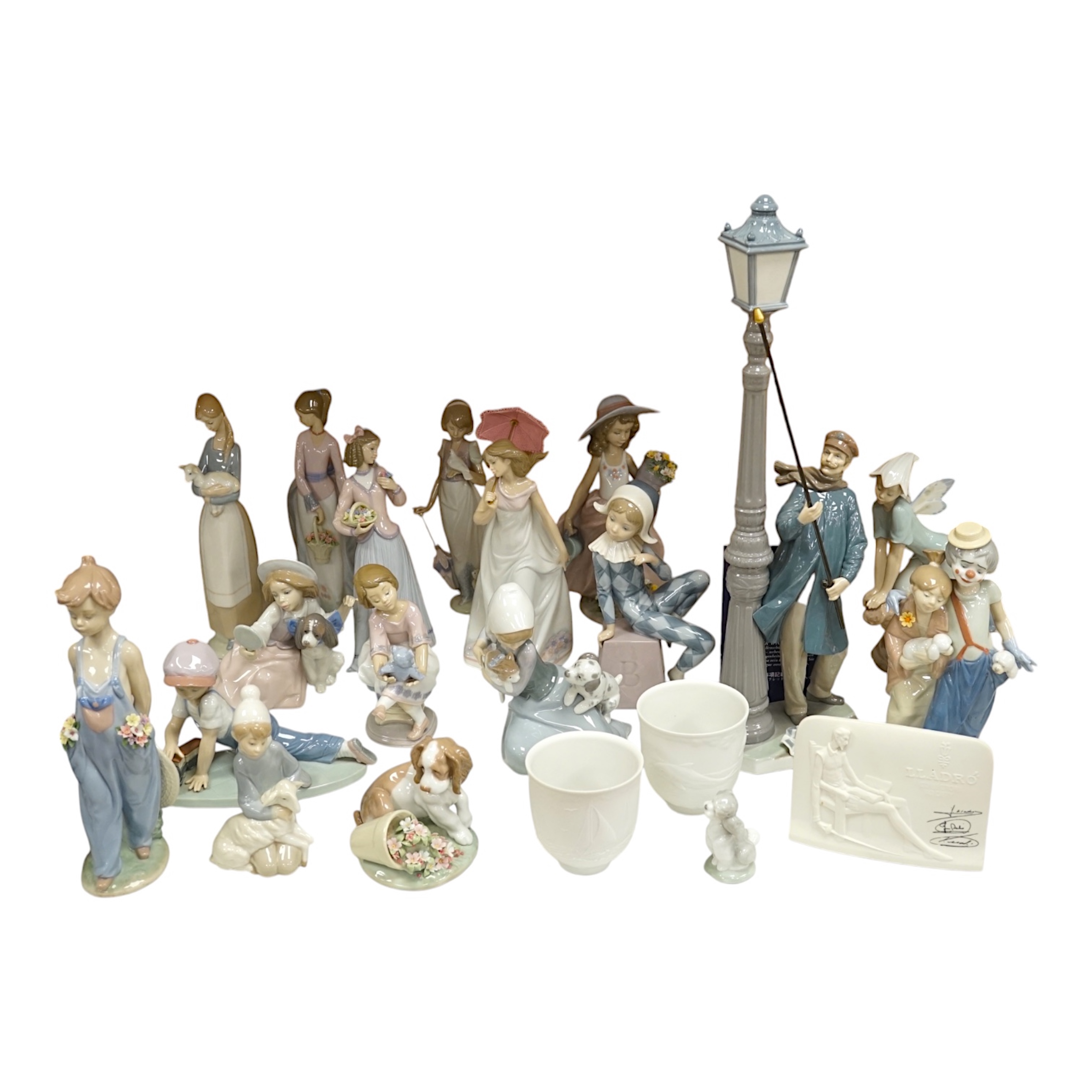 A group of Lladro figures to include ‘Lamplighter’ and ‘All aboard’, largest 48cm high. Condition - good